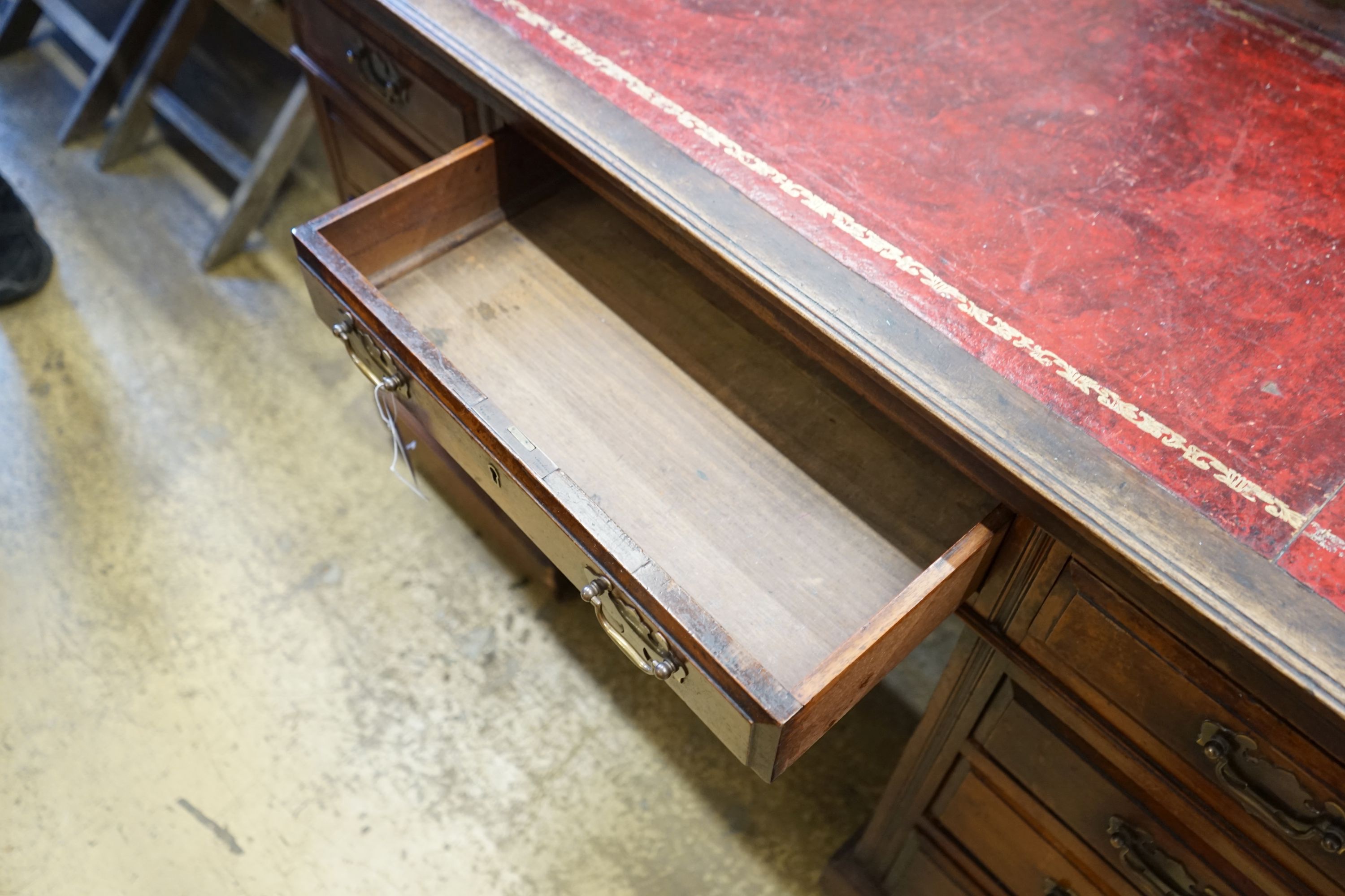 An early 20th century nine drawer writing desk, width 122cm depth 57cm height 75cm